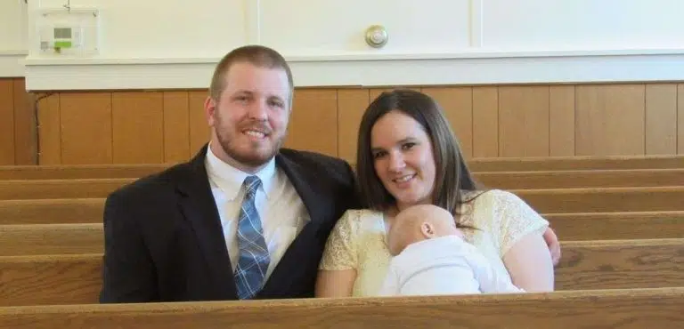 Mommy, Daddy and baby sitting in the church pews