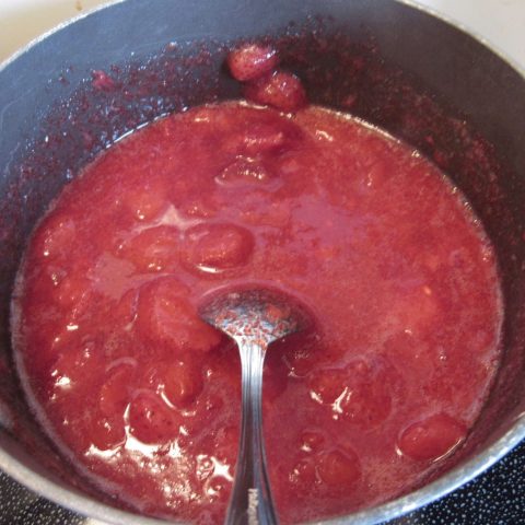 Strawberry pie filling on the stove