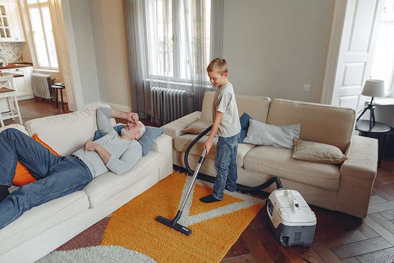 A boy helping to clean the house