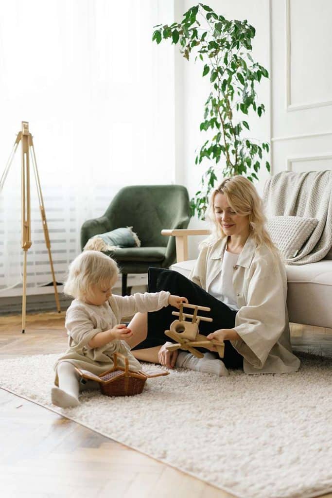 Mother and child sitting on a clean safe floor from non toxic floor cleaner