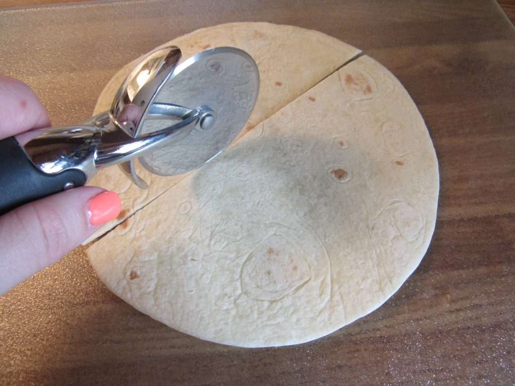 Fruit Dip with Greek Yogurt 5 Tortilla laid on a flat surface and sliced with a pizza cutter.