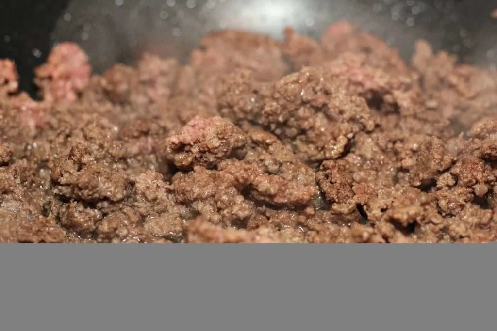 Closeup shot of the browned ground beef in pan.