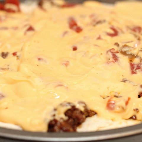 Cheesy Taco Casserole in pan with melted cheese on top