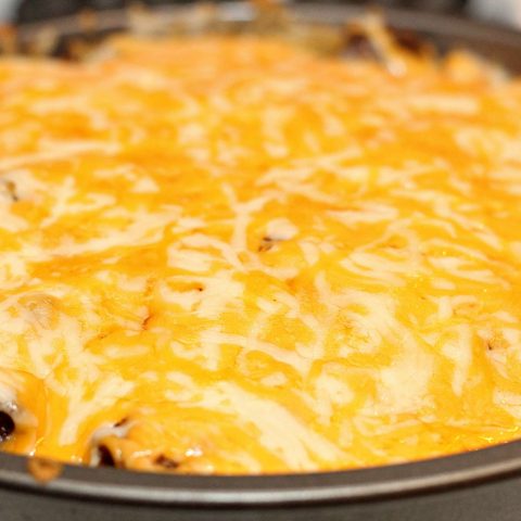 Taco Casserole with melted cheese on top in pan