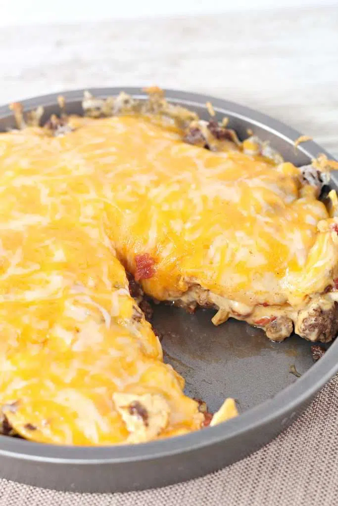 Cheesy Taco Casserole in pan with slice taken out 