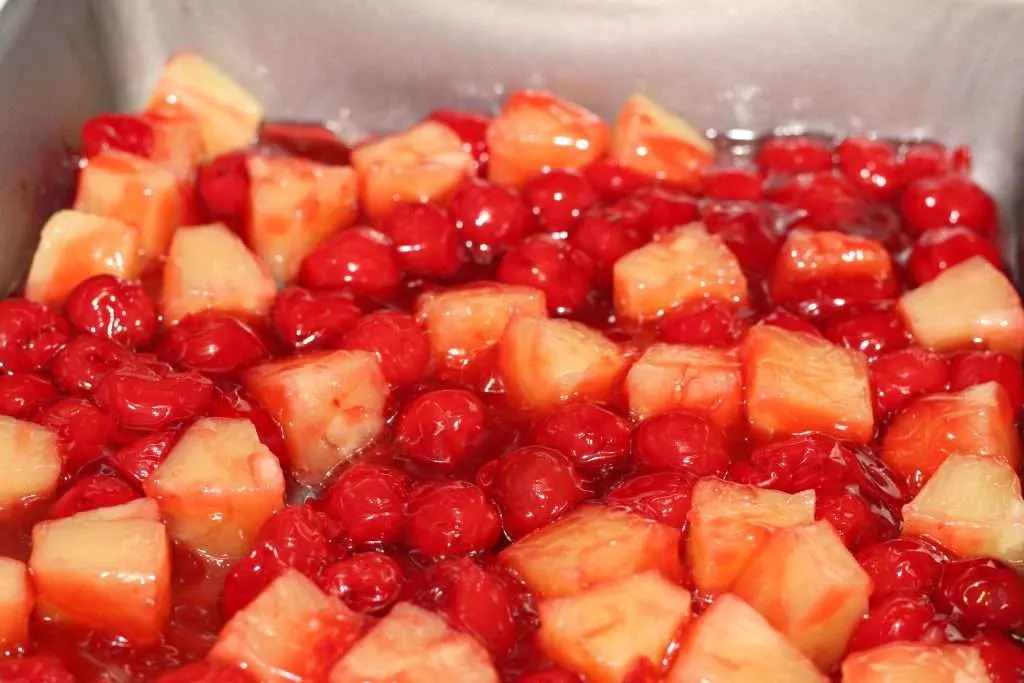 Cherry Pineapple Dump Cake (Only 5 Ingredients and 1 Pan!) 6 Cherry pineapple filling mixed in pan