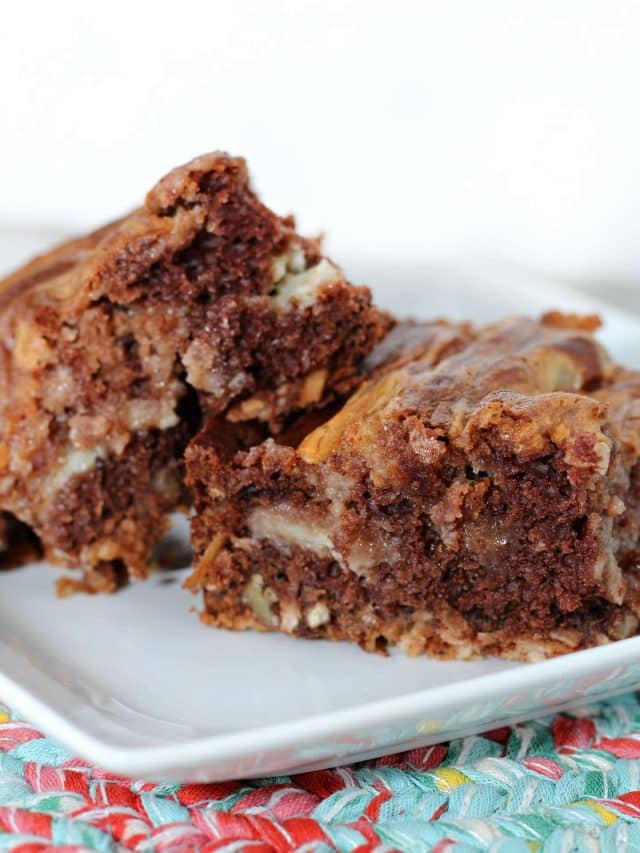 Three square slices of the finished Easy German Chocolate Bars on a square white plate.
