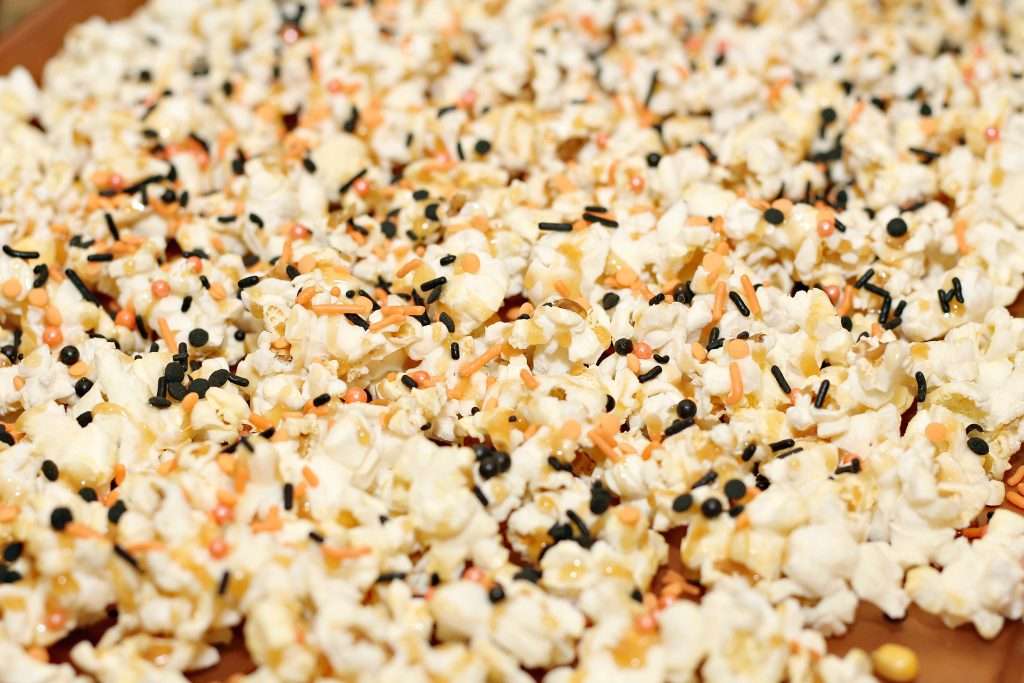 Halloween Popcorn 5 Freshly popped popcorn with black and orange melted chocolate.