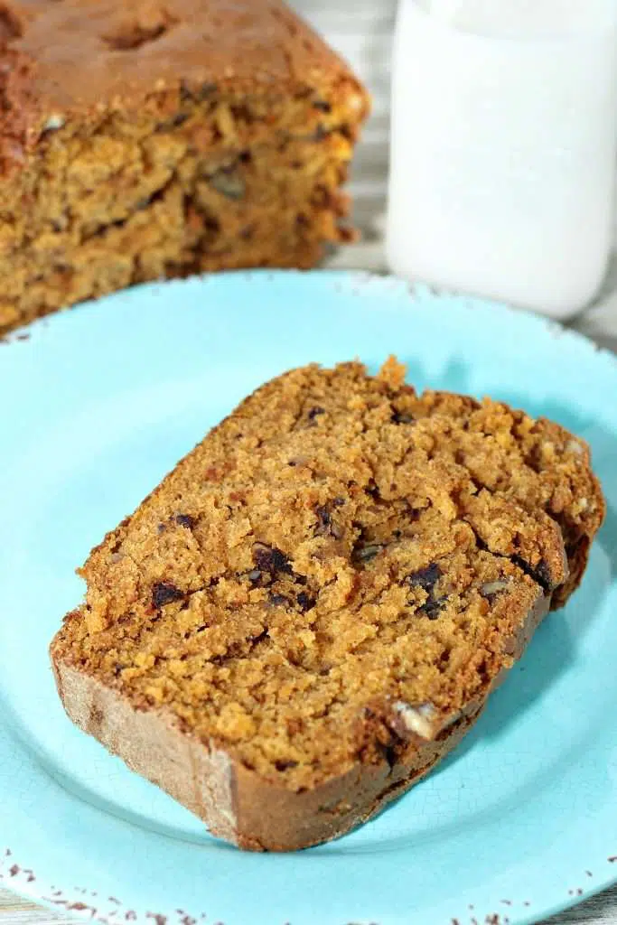 5 Step Pumpkin Bread Delicious Pumpkin Bread on teal plate with full loaf in background.