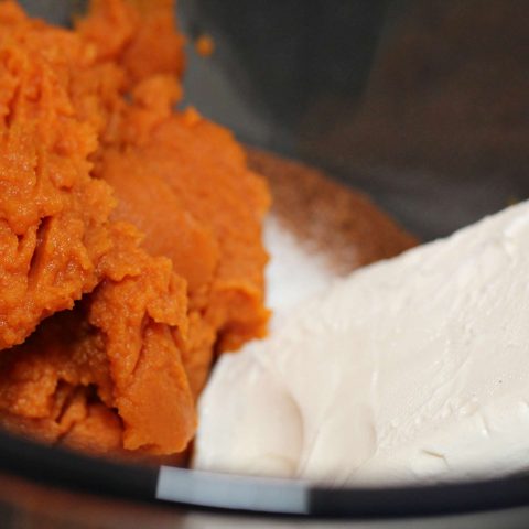 Bowl with cream cheese and canned pumpkin pie filling.