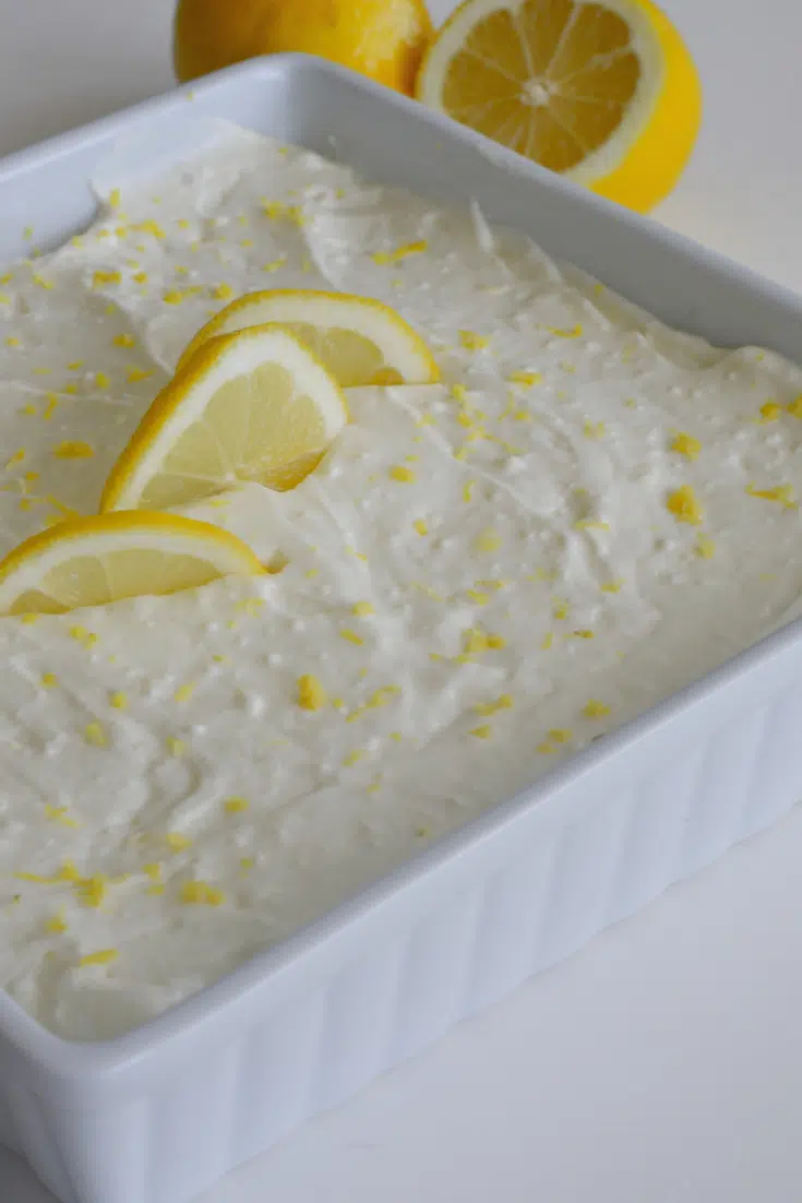 finished pan of 6 ingredient lemon bars with lemon slices and zest