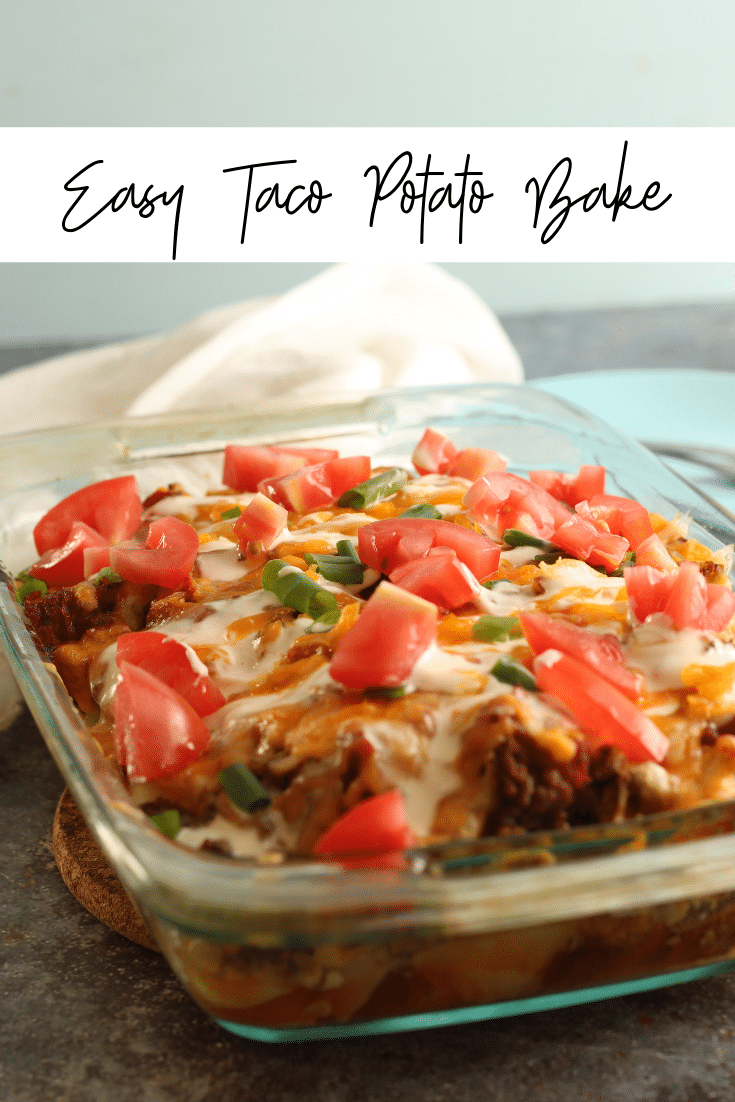 taco potato bake in glass baking pan, topped with fresh tomatoes