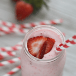 strawberry lemonade shake in mason jar with red and white striped straw