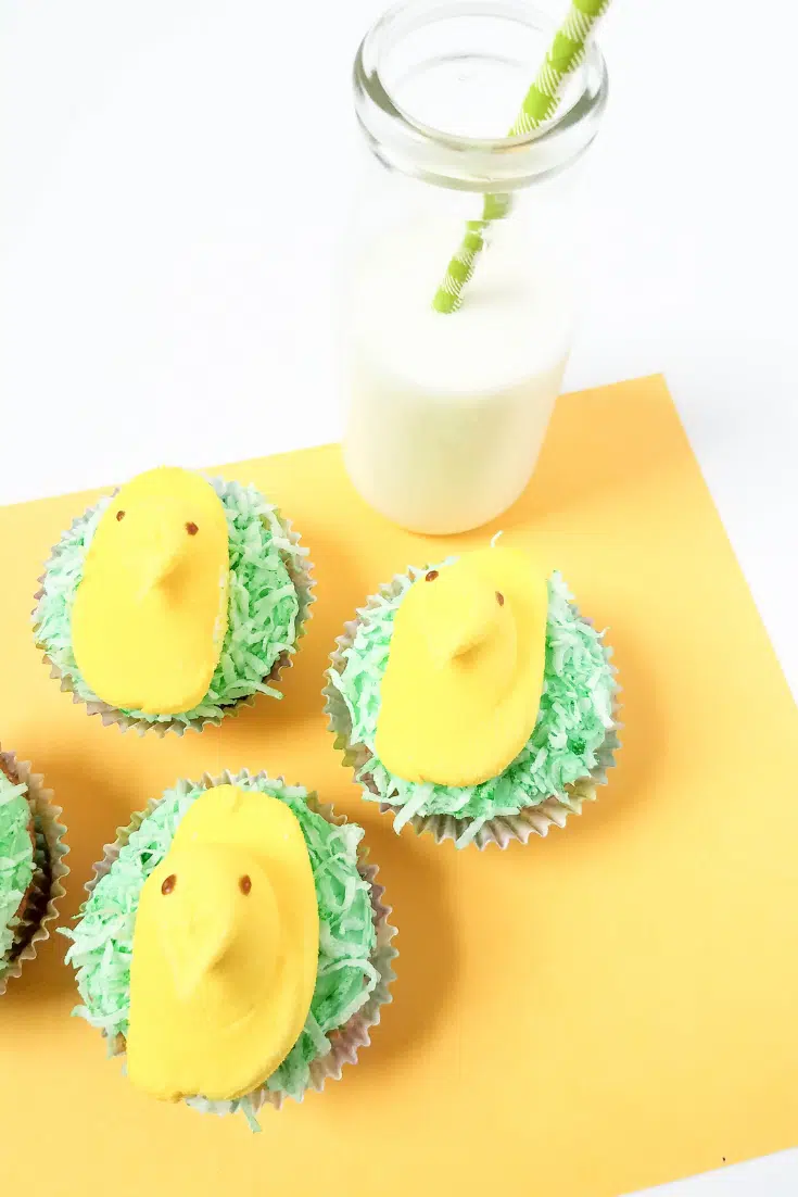 peeps cupcakes on placemat with glass of milk