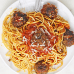 spaghetti and meatballs on white plate