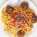 spaghetti and meatballs on white plate