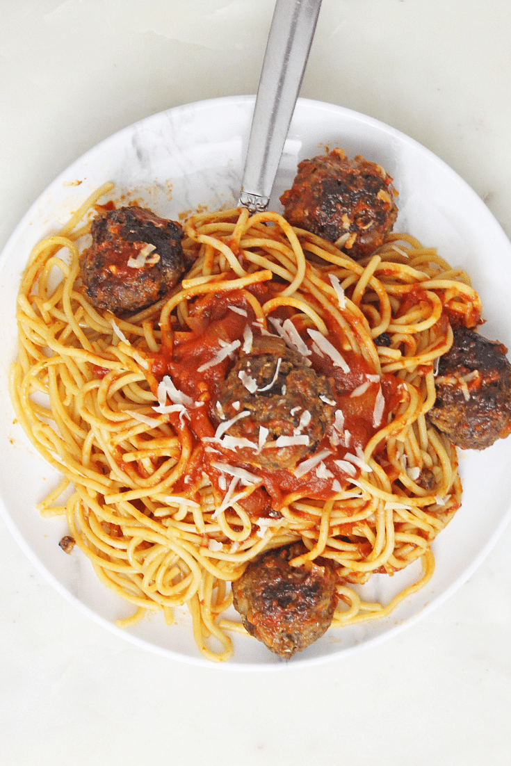 spaghetti and meatballs on white plate