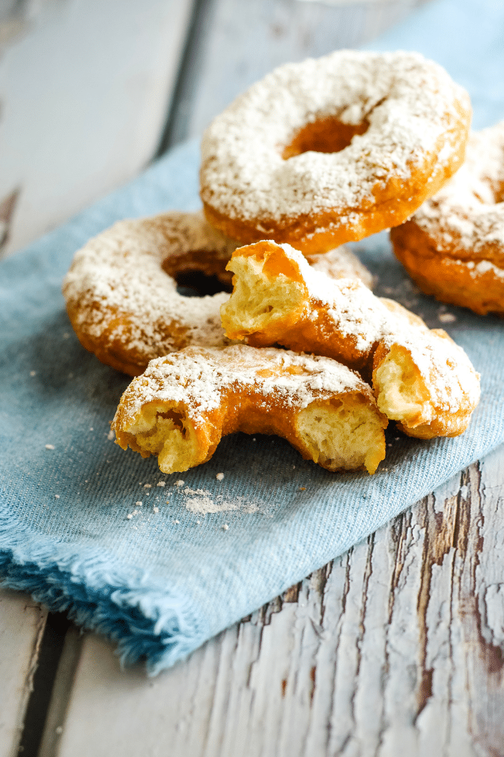 donuts on blue plate, with one cut in half