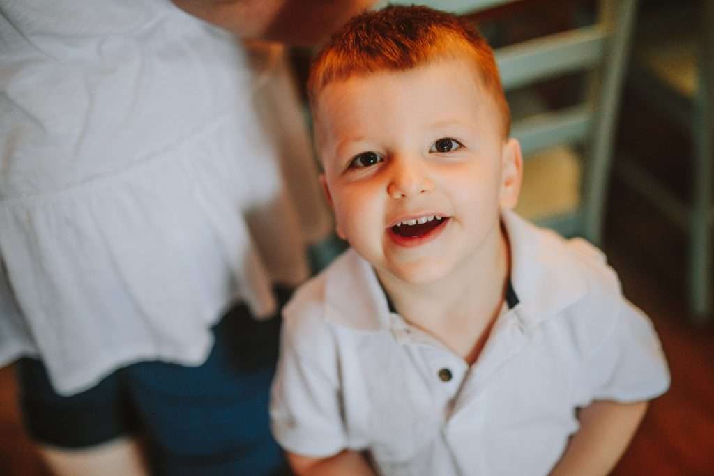 Toddler boy in white polo shirt 