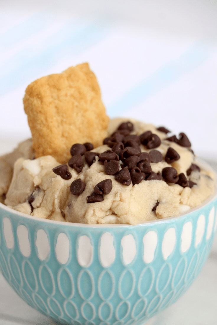 Easy No- Bake Cookie Dough Dip 5 cookie dough dip in blue bowl with cookie inside