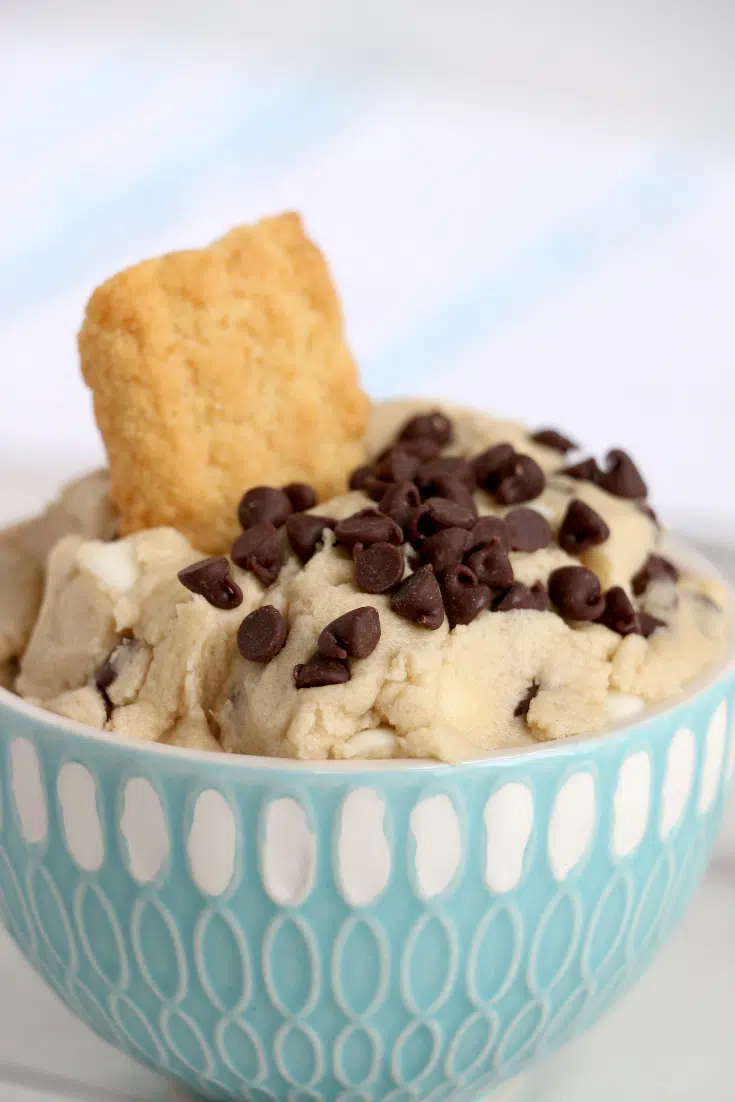 Easy No- Bake Cookie Dough Dip 5 cookie dough dip in blue bowl with cookie inside
