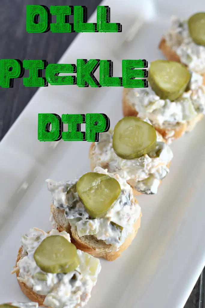dill pickle dip on bread slices, served on a white plate
