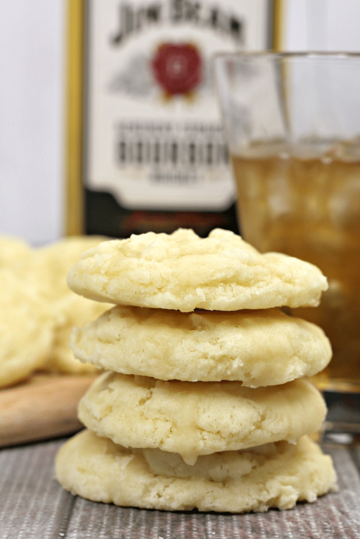 butter cookies stacked, with bottle of bourbon in background