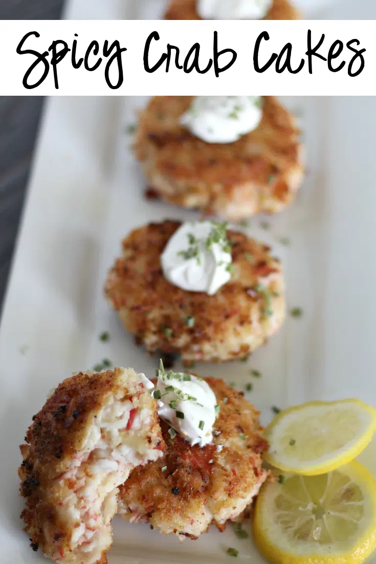 spicy crab cakes on white plate with lemon slice