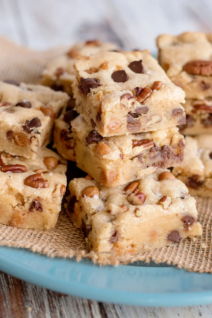 salted caramel chocolate chip cookie bars on blue plate