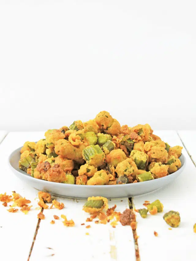 white plate of fried okra on wooden background
