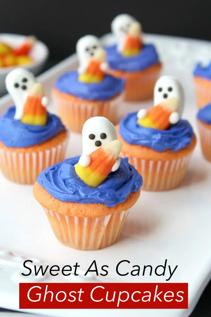 ghost candies on top of blue frosted cupcakes