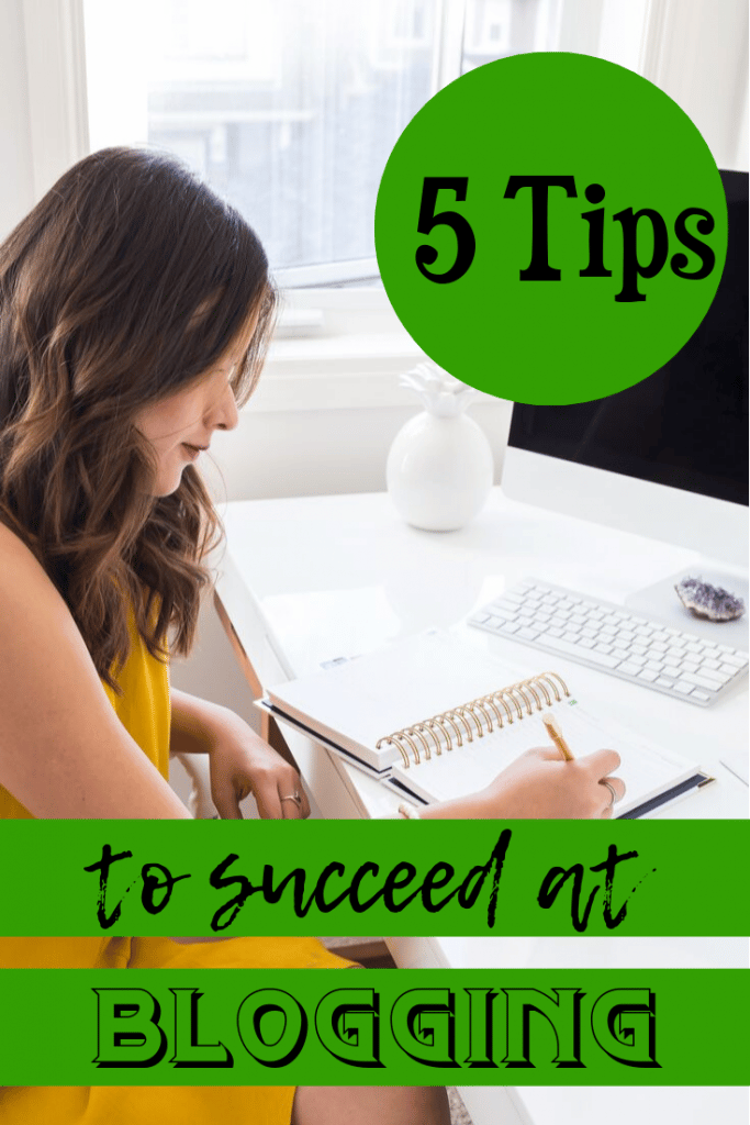 woman sitting at desk writing in journal