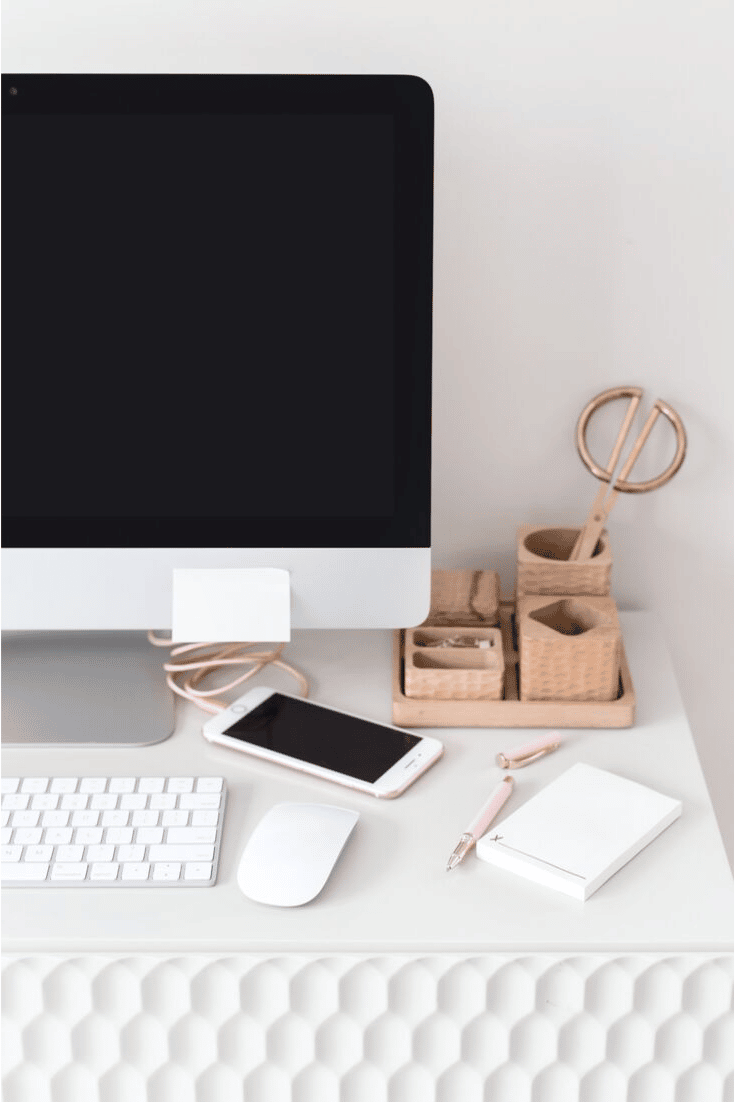 comupter monitor, keyboard and cellphone on work desk