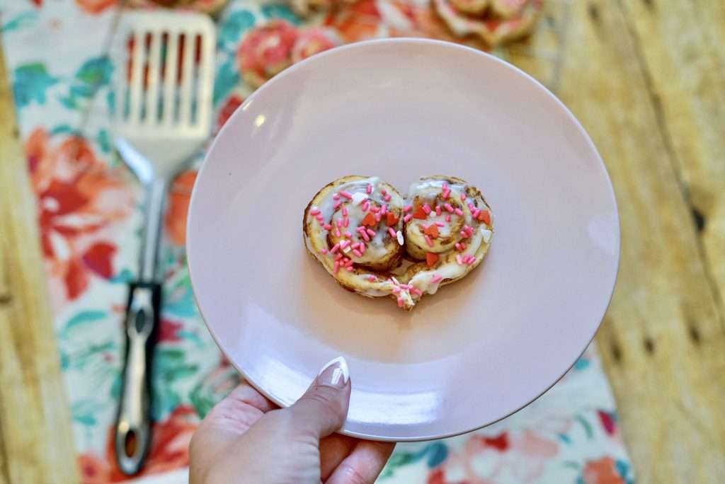 Heart shaped cinnamon rolls decorated with sprinkles