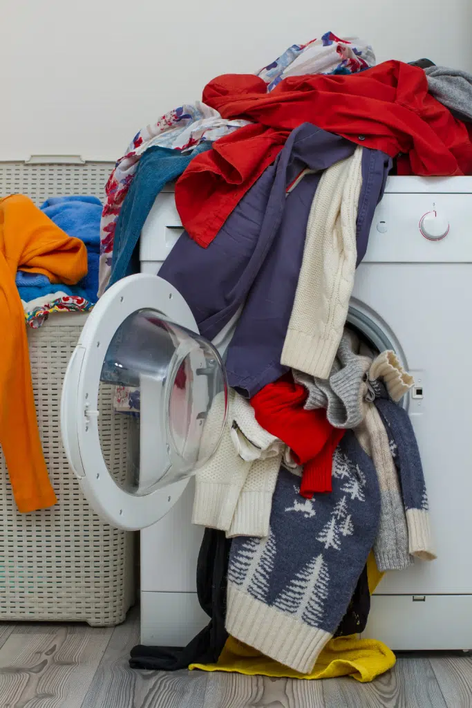 laundry pouring out of washing machine