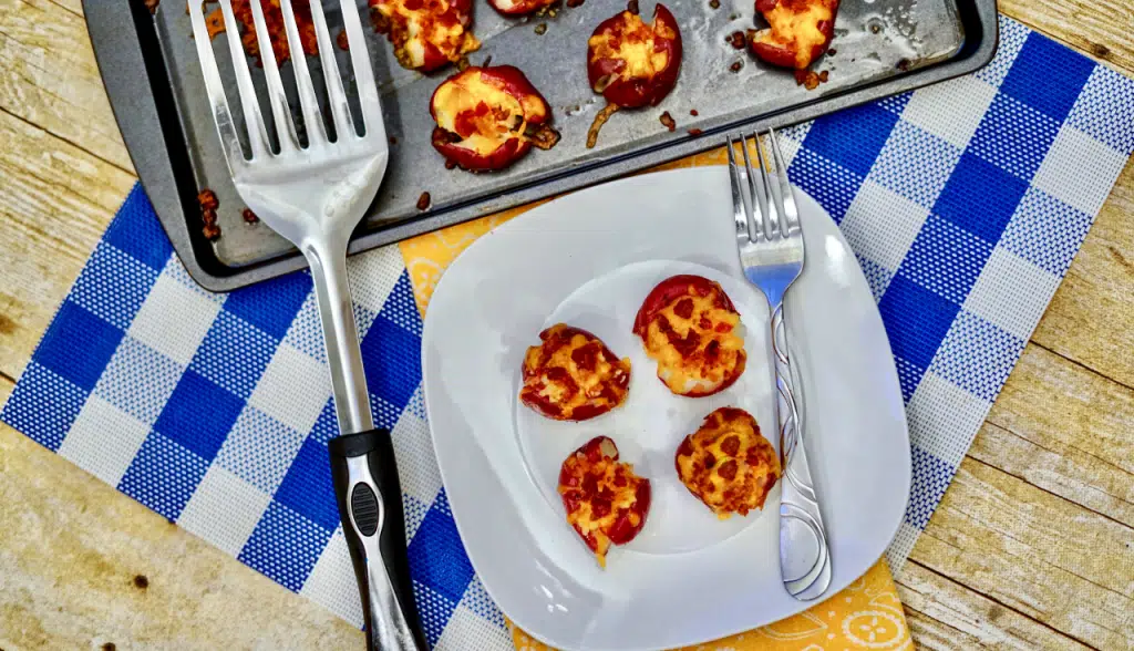 smashed potatoes on white plate with fork on side