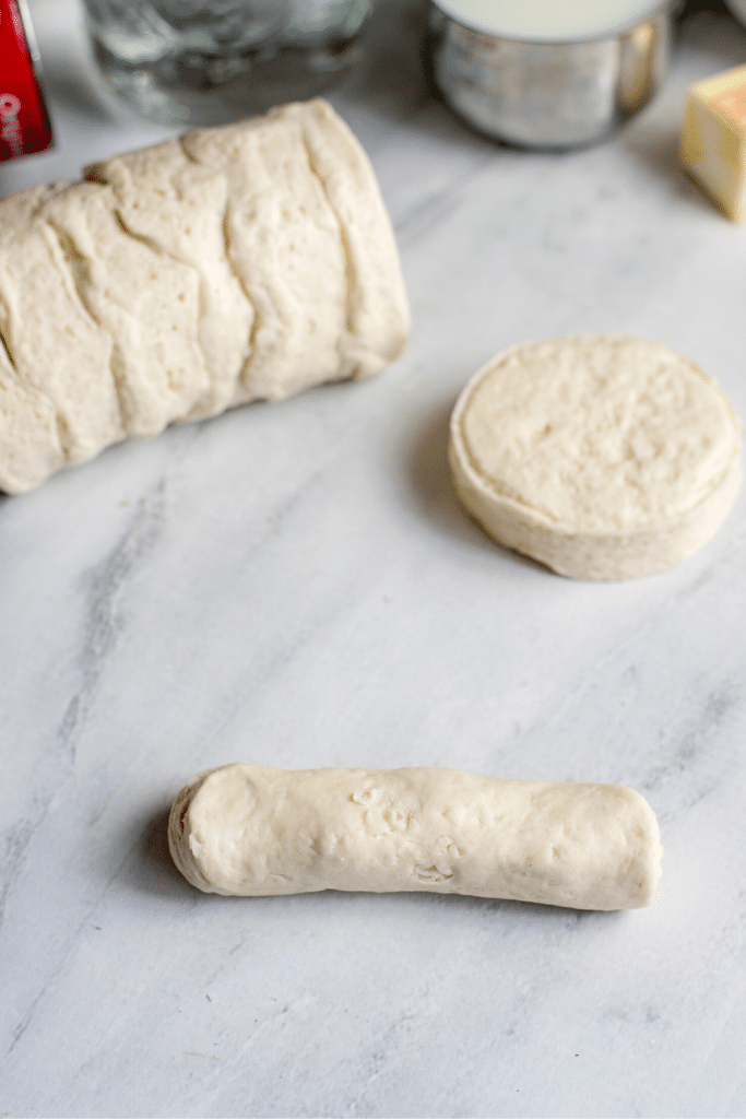 Soft Pretzels with Biscuit Dough 11 Canned biscuit dough rolled out on a marble surface and ready to be shaped into pretzels.