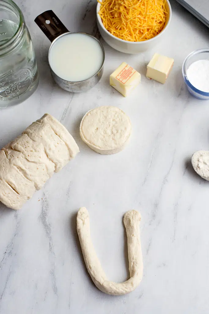 Biscuit dough roll in a U-shape.