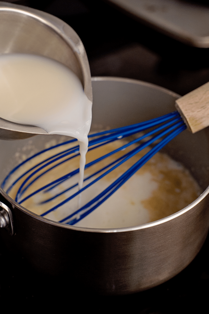 Soft Pretzels with Biscuit Dough 22 Milk poured into the pot with melted butter and flour.