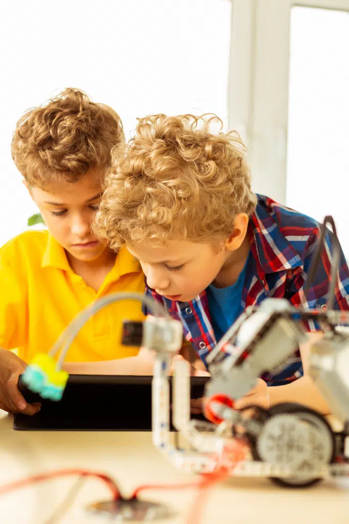 2 boys looking at a science activity