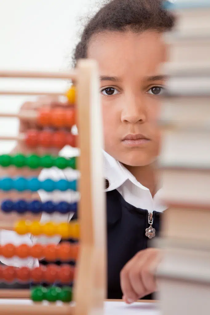 little girl looking at abacus