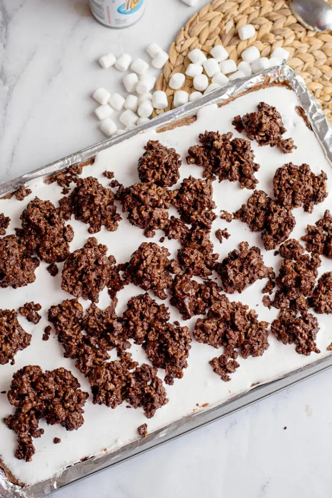 Chocolate marshmallow bars dessert topped with chocolate Rice Krispies topping.