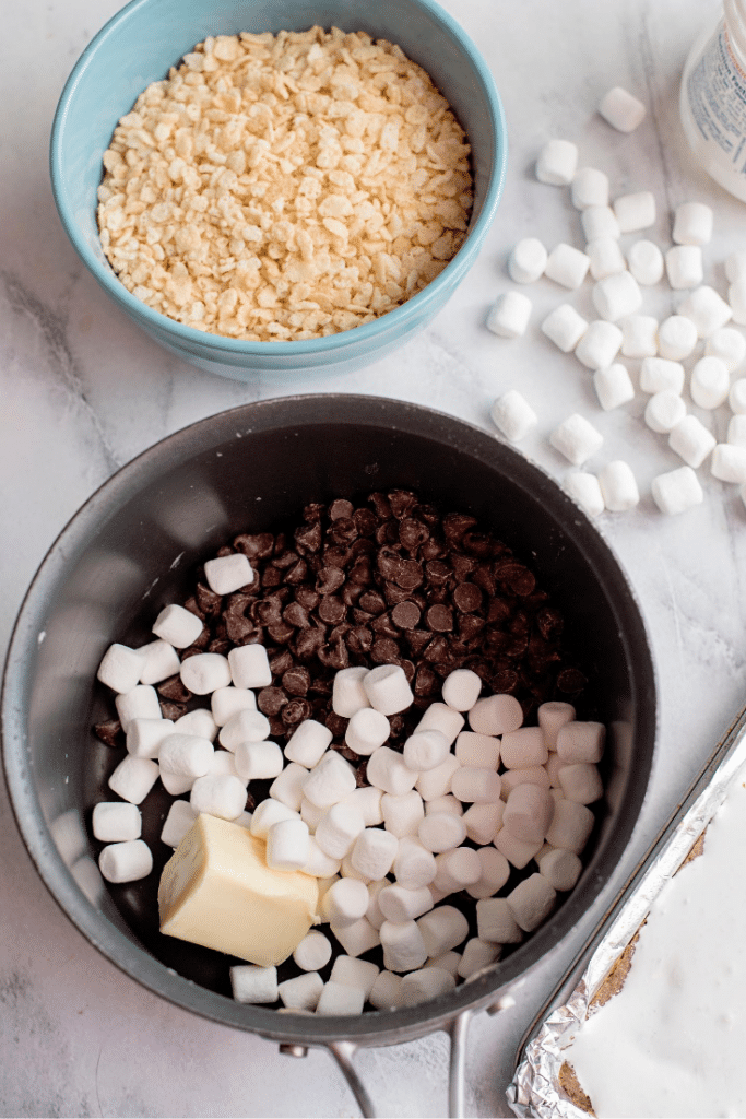 Chocolate Marshmallow Bars 21 Small saucepan with chocolate chips, butter, and mini marshmallows.