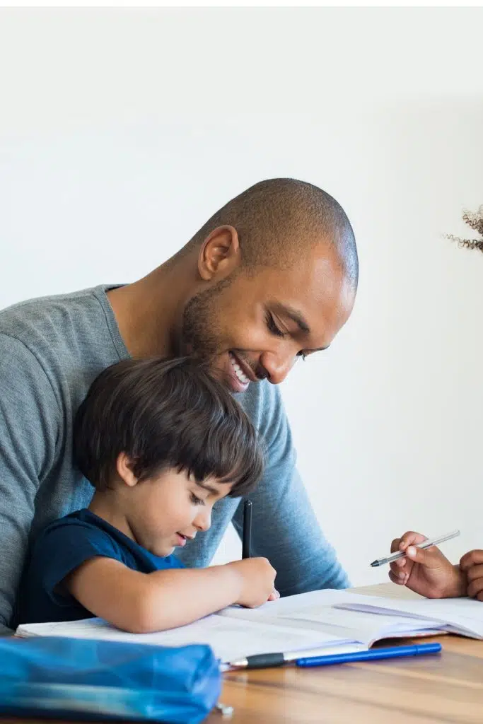 child learning to write with dad  in the  fall themed abc activity sheets