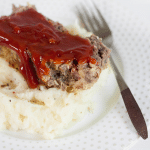 venison meatloaf with mashed potatoes on a white plate