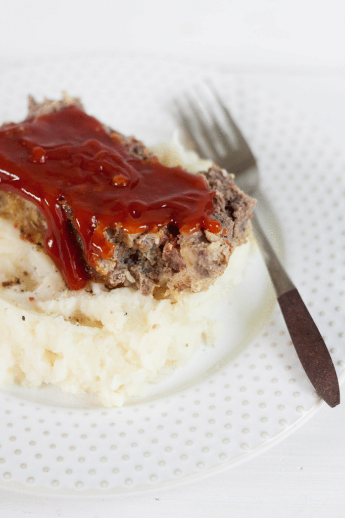 Venison Meatloaf 6 venison meatloaf with mashed potatoes on a white plate