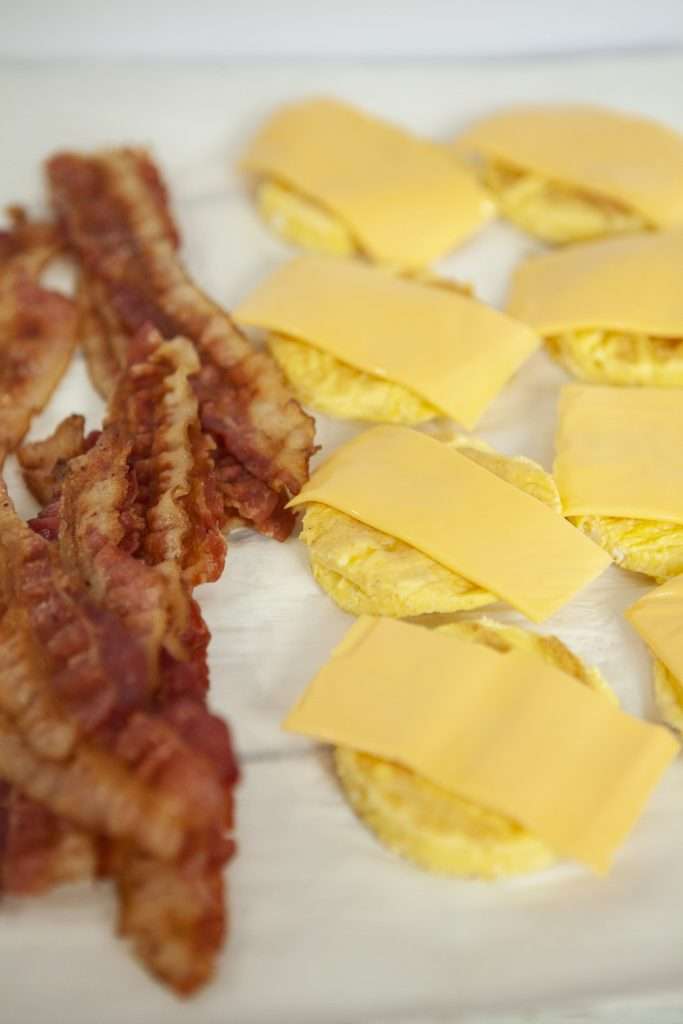 Bacon Egg and Cheese Biscuit (Weight Watchers Recipe) 8 Slices of crispy bacon, halved baked biscuits with slices of cheese on top.