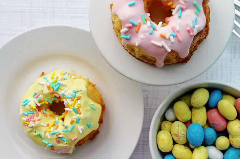 Yellow and pink mini bundt cakes with chocolate candy Easter eggs