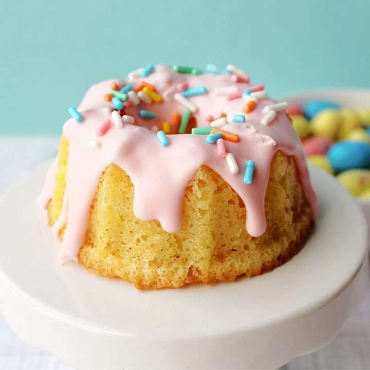 Easter Mini Bundt Cake Recipe (From Box Cake Mix) 7 Easter mini bundt cake recipe with pink icing on a blue background