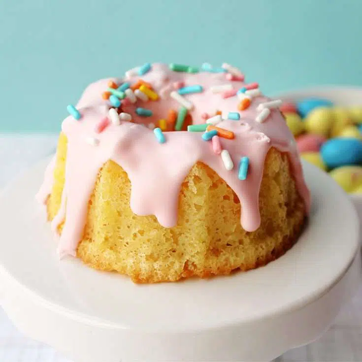 Easter mini bundt cake recipe with pink icing on a blue background